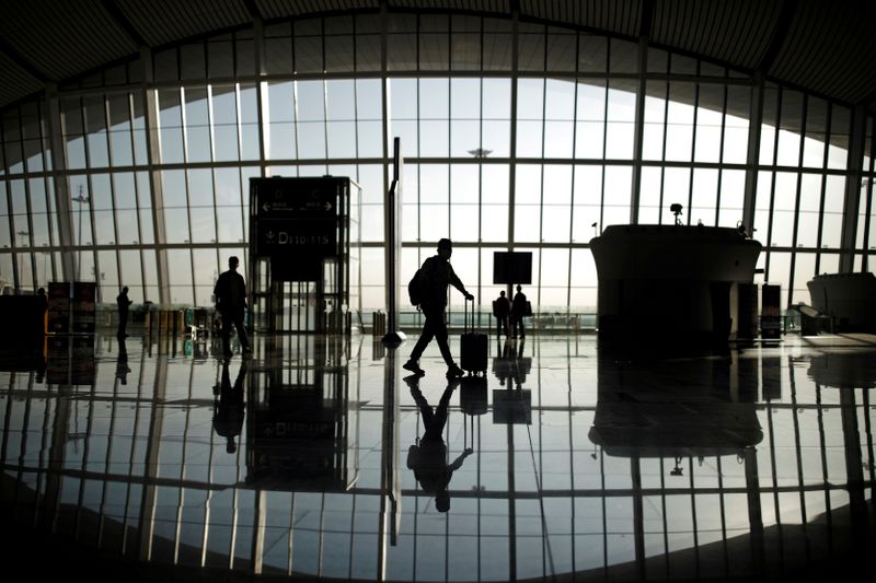 FILE PHOTO: Travellers are seen silhouetted at Beijing Daxing International