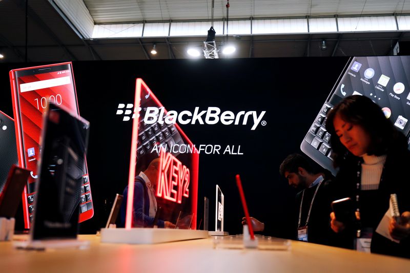 Visitors attend the Blackberry booth at the Mobile World Congress