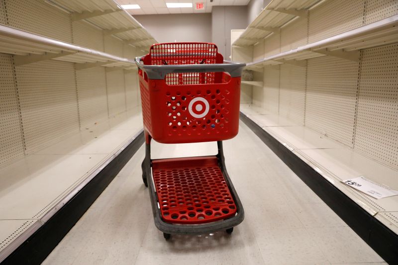 A shopping cart sits in an aisle empty of cleaning