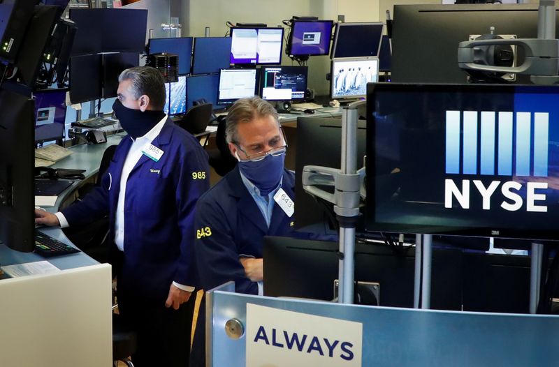 Traders wearing masks work, on the first day of in