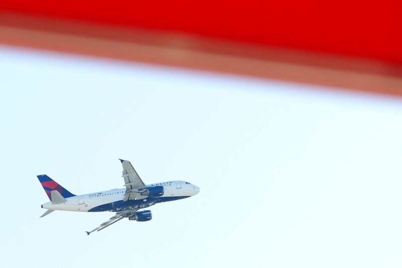 FILE PHOTO: An airplane flies over Hartsfield–Jackson Atlanta International Airport