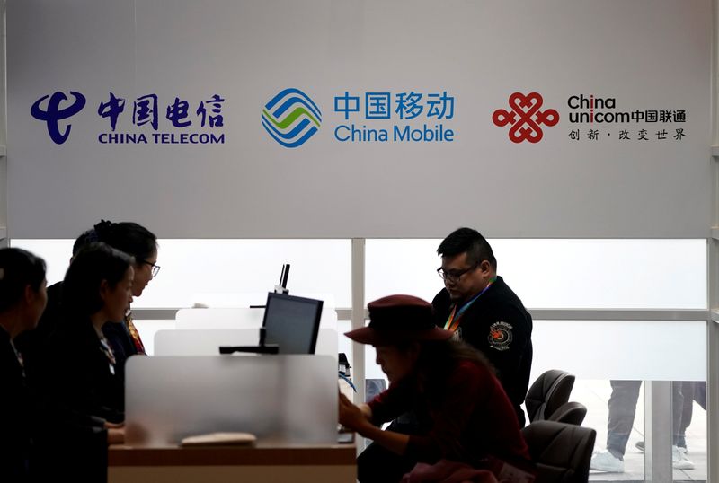 FILE PHOTO: Signs of China Telecom, China Mobile and China