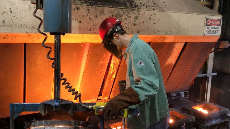 A worker pours hot metal at the Kirsh Foundry in