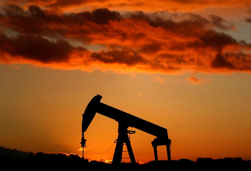 FILE PHOTO: A oil pump is seen at sunset outside