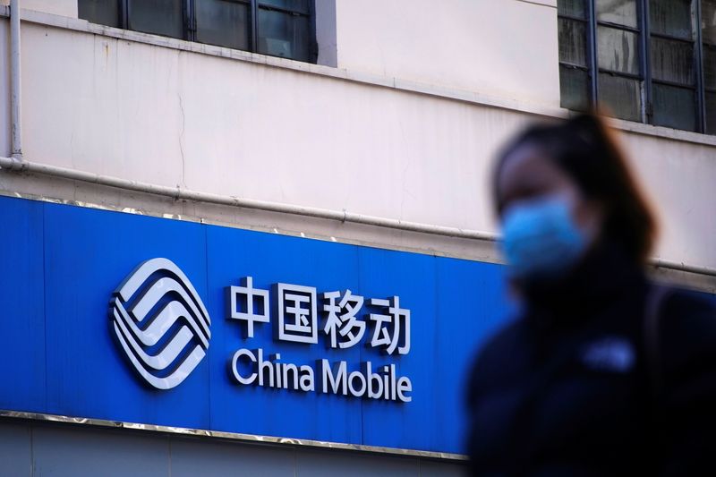 A sign of China Mobile is seen on a street,