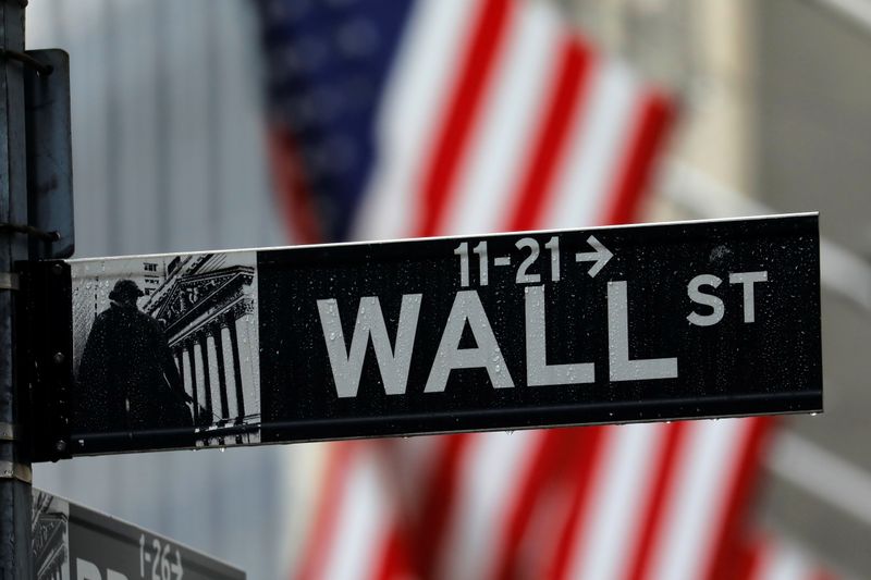 Raindrops hang on a sign for Wall Street outside the
