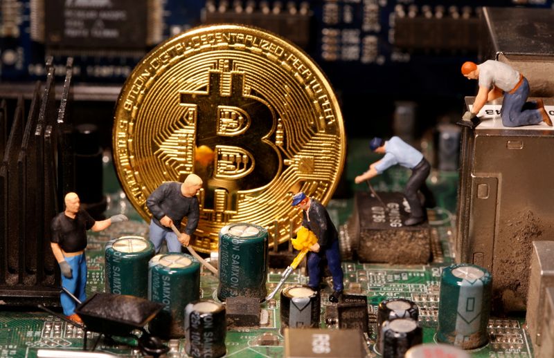 A representation of virtual currency Bitcoin and small toy figures