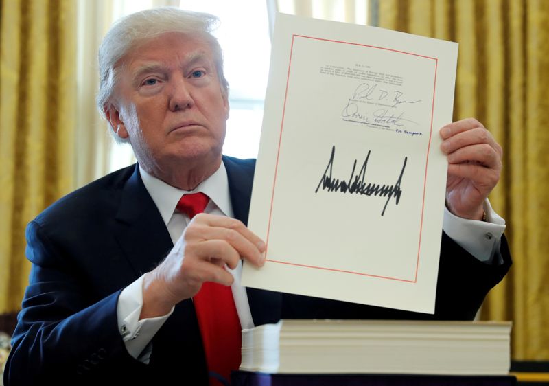 FILE PHOTO: U.S. President Trump displays signature after signing tax