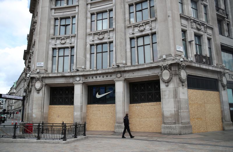 Shops are seen boarded up in Oxford Street, in London