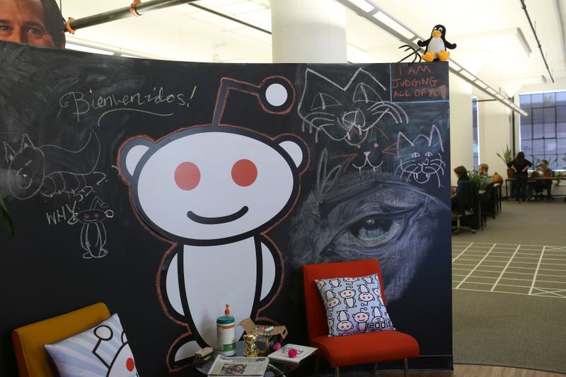 A Reddit mascot is shown at the company’s headquarters in
