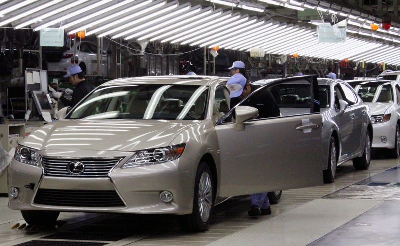 Toyota workers inspect the new Lexus ES vehicles at a