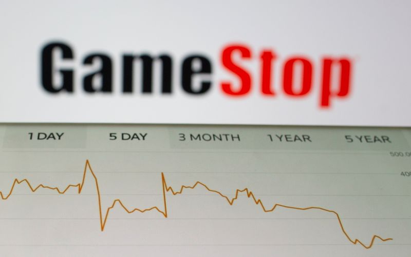 GameStop stock graph is seen in front of the company’s