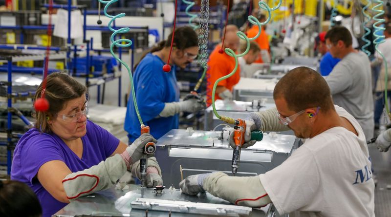 Workers assemble built-in appliances at the Whirlpool manufacturing plant in