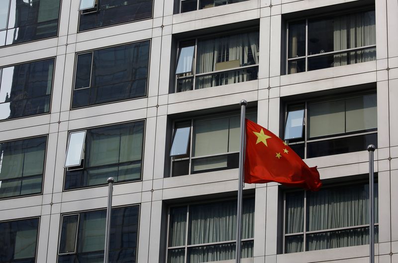 FILE PHOTO: Chinese national flag flutters near the building of
