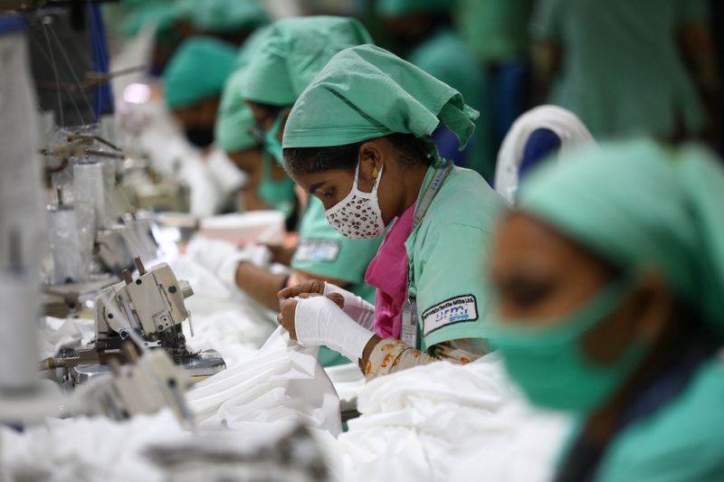Garment employees work in a sewing section of the Fakhruddin
