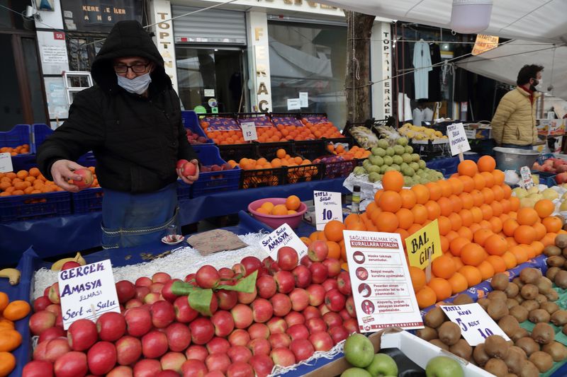 FILE PHOTO: Seref Geyik waits for customers at his stall