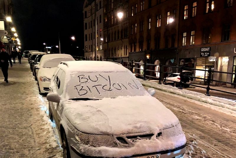 FILE PHOTO: A car with a sign “Buy Bitcoin” written