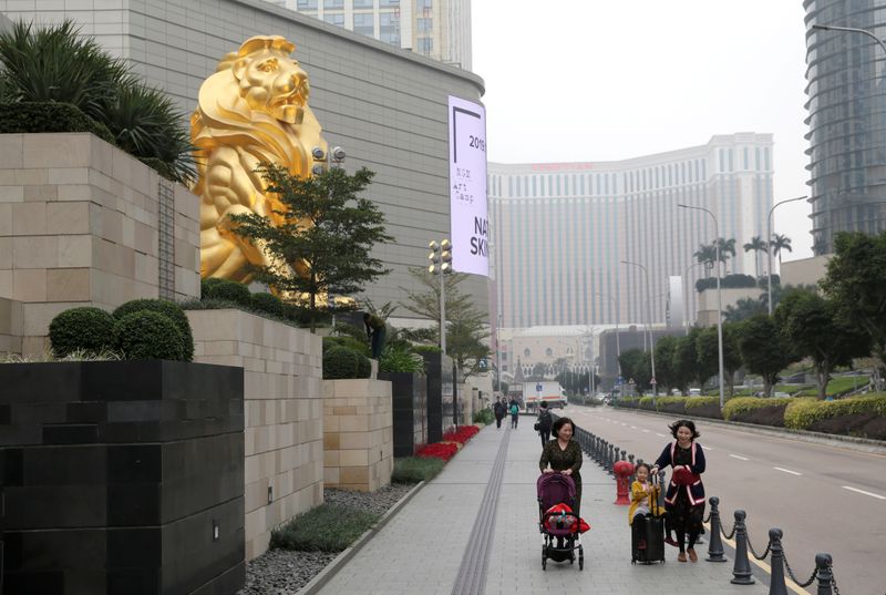 FILE PHOTO: Women and their children walk past the MGM