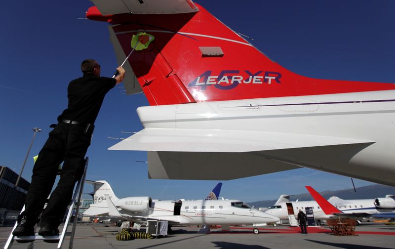 FILE PHOTO: A staff cleans the tail of a Bombardier