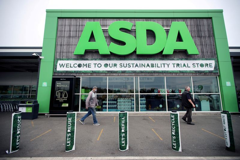 FILE PHOTO: Shoppers walk past the UK supermarket Asda, as