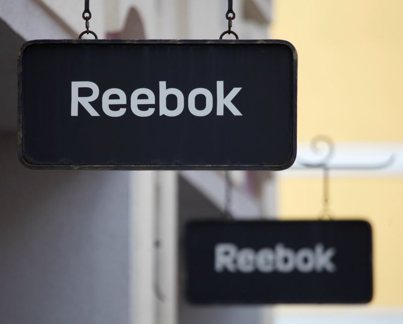 Boards with Reebok store logo are seen on a shopping