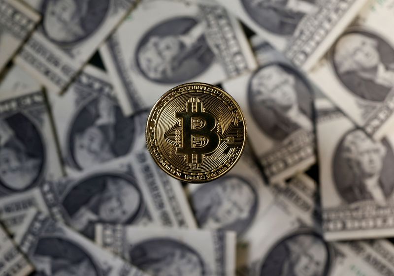 FILE PHOTO: A bitcoin (virtual currency) coin placed on Dollar