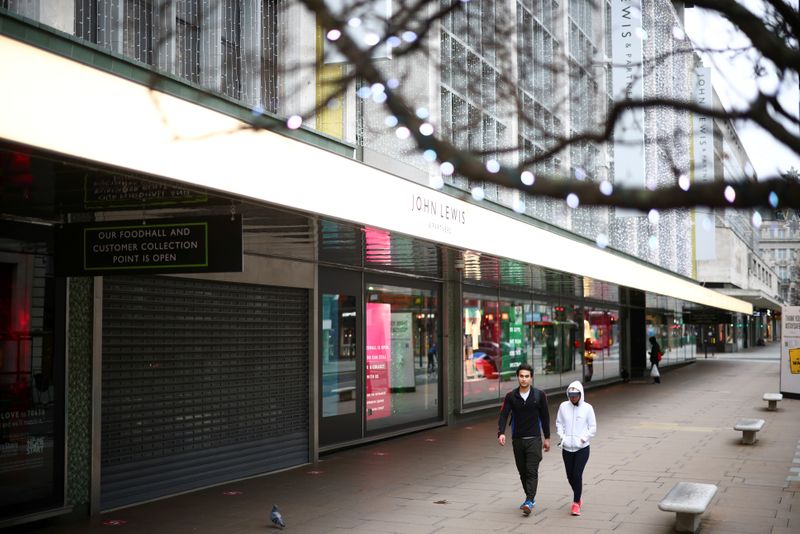 FILE PHOTO: People walk along Oxford Street as shops remain