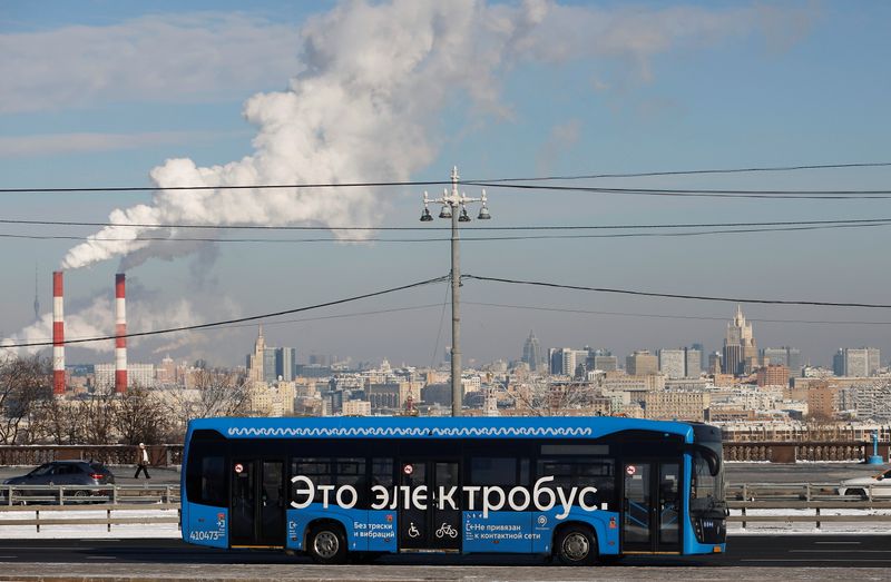 An electric bus travels along a road in Moscow