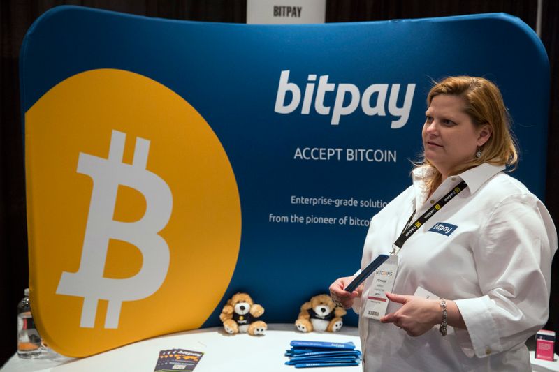 A woman explains how bitpay, a company designed to help
