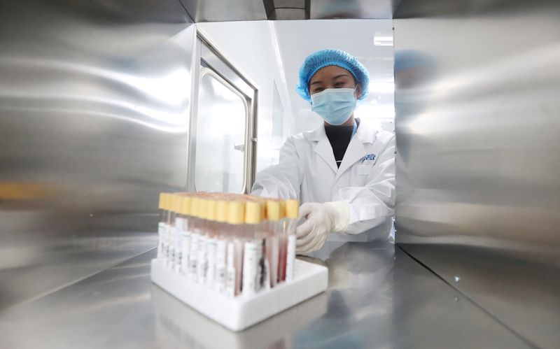 FILE PHOTO: A technician works at a genetic testing laboratory