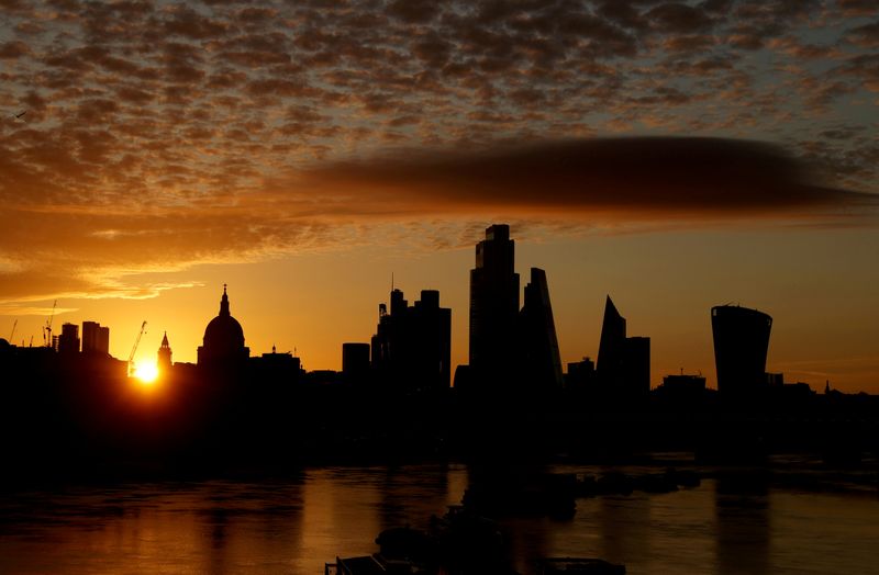 FILE PHOTO: The sun rises behind the skyline of St