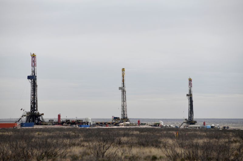 FILE PHOTO: Drilling rigs operate in the Permian Basin oil