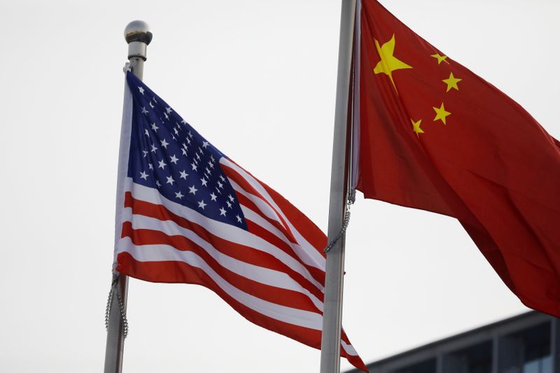 Chinese and U.S. flags flutter outside the building of an