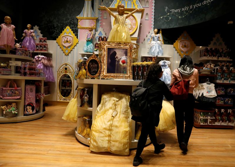 FILE PHOTO: Customers look at “Beauty and the Beast” merchandise