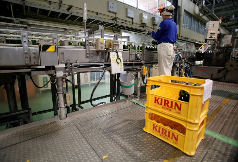 Employee works at a beer production line at Japanese brewer