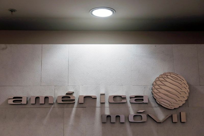 The logo of America Movill is seen on a wall