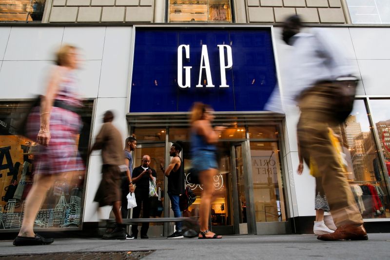 FILE PHOTO: People pass by the GAP clothing retail store