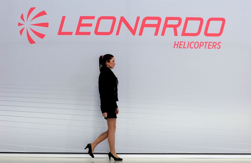 FILE PHOTO: A hostess walks past a Leonardo’s helicopters logo