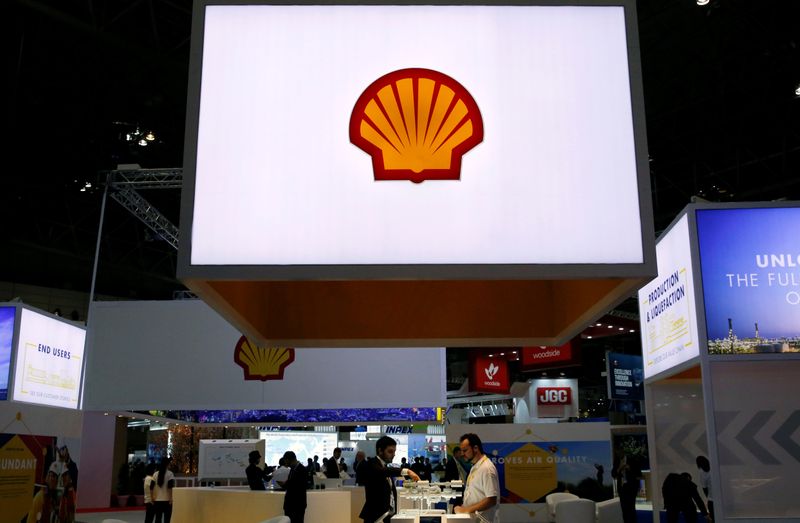 Staff members work at the booth of Royal Dutch Shell