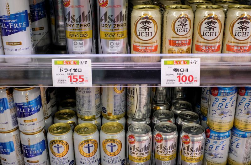 Various cans of alcohol-free beers are displayed on a supermarket