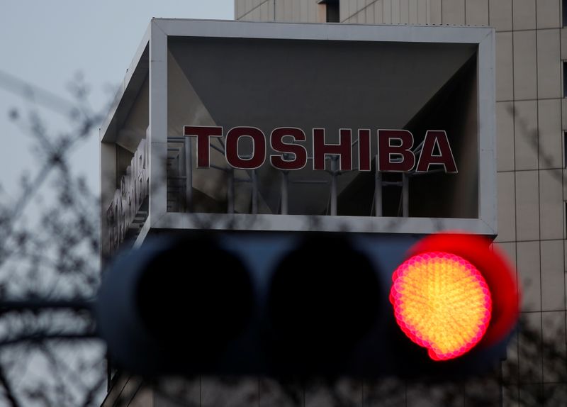 The logo of Toshiba Corp is seen behind a traffic
