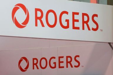 FILE PHOTO: Rogers Communications logos are seen above a booth