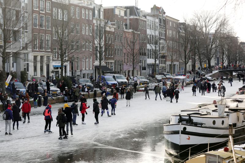 FILE PHOTO: People ice skate during a cold snap across