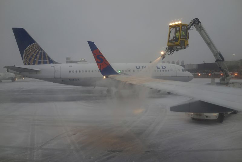 FILE PHOTO: A Sun Country Airlines plane’s wing is de-iced