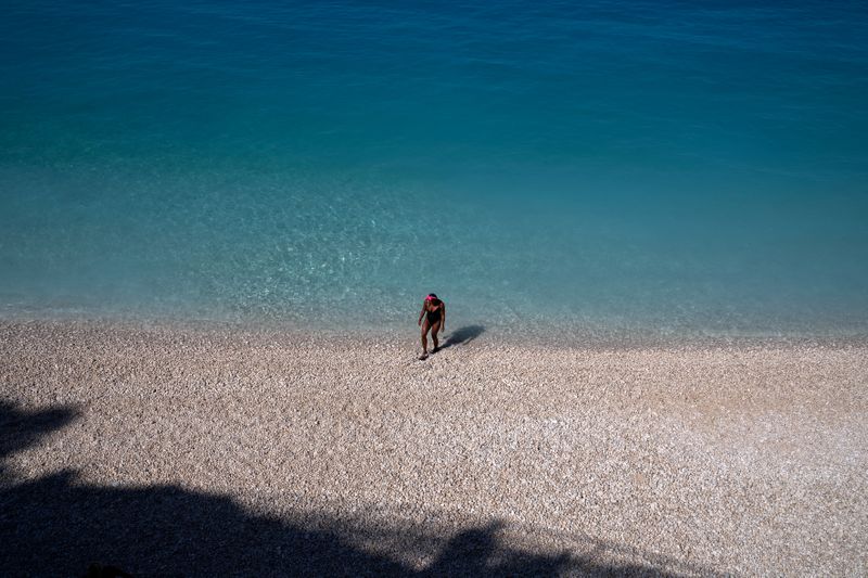 FILE PHOTO: A woman on Porto Katsiki beach on the