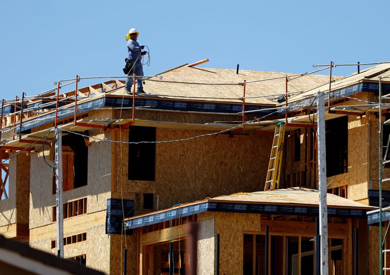 FILE PHOTO: A worker walks on the roof of a