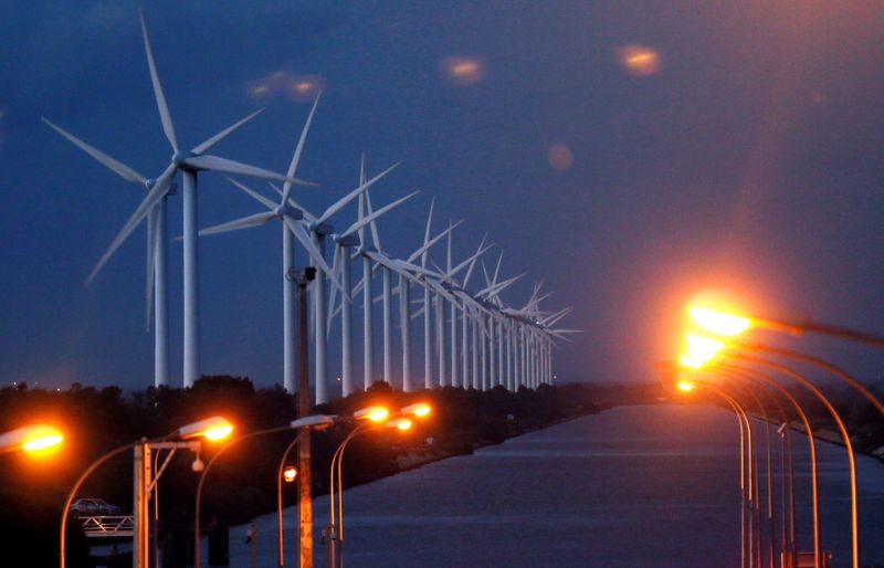 FILE PHOTO: Power-generating windmill turbines are seen near Port Saint