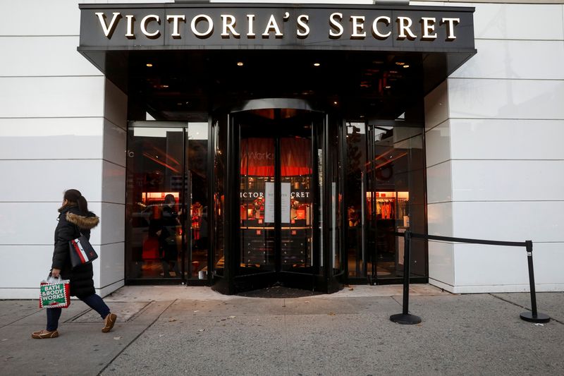 A shopper passes by a Victoria’s Secret retail store, as