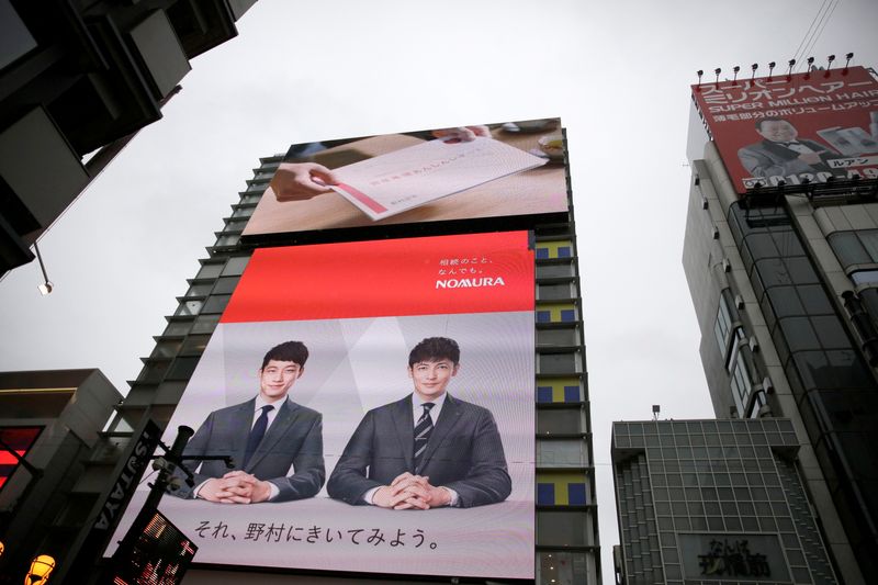 A Nomura commercial is shown on a television screen in