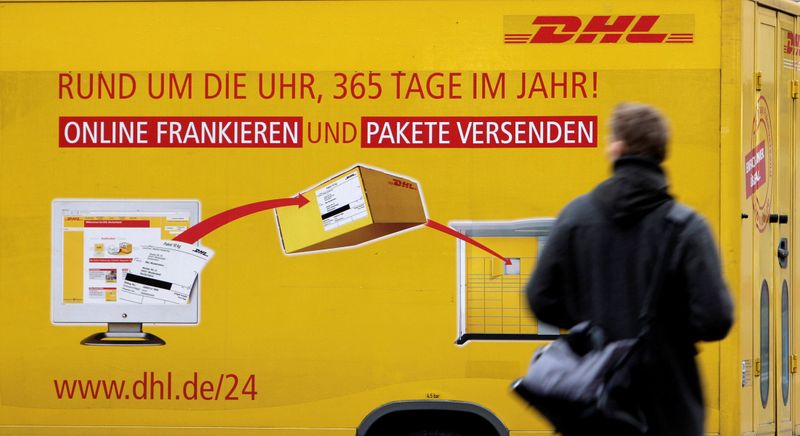 FILE PHOTO: A man passes a DHL truck in Berlin,